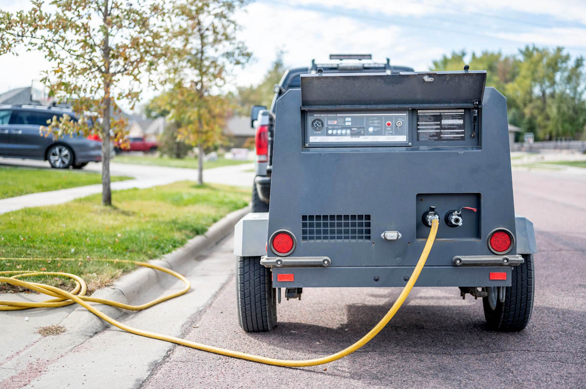 A work truck at a residential home starting the Salt Lake City sprinkler winterization process.